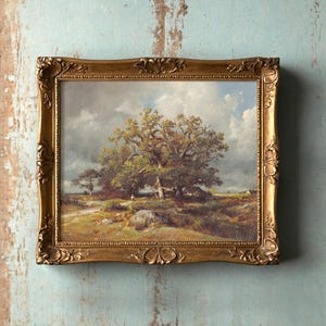 Ornate framed landscape painting on worn, light blue wall. Depicts a large tree under cloudy sky, evoking a peaceful, rustic scene.