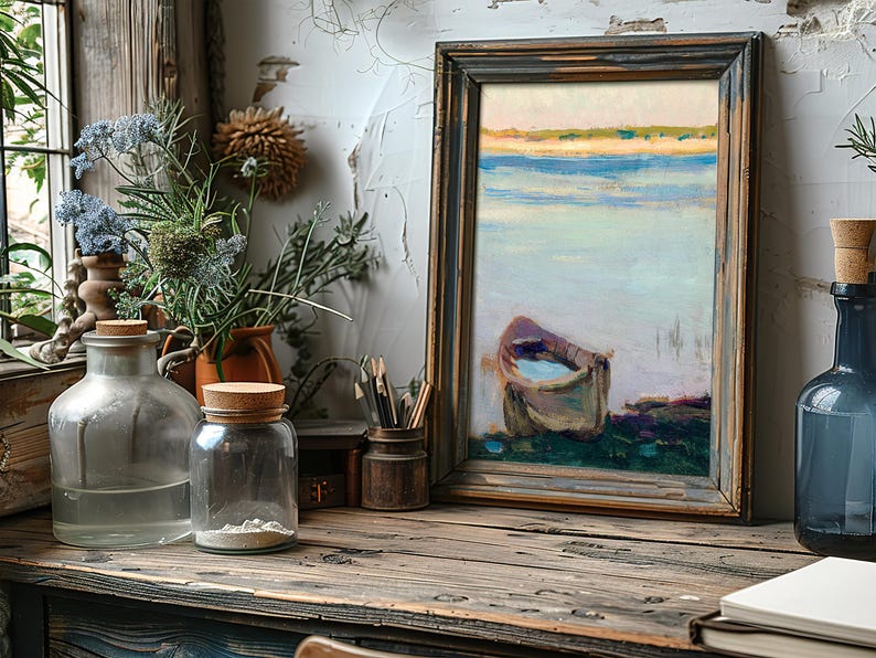 A rustic wooden desk features glass bottles and wildflowers beside a framed painting of a boat on serene water, evoking a calm, artistic atmosphere.