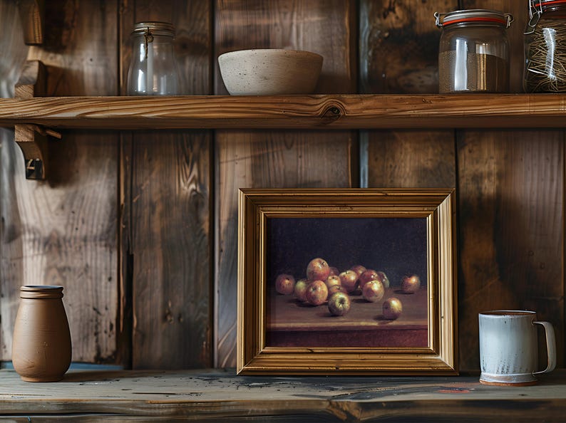 A rustic wooden shelf holds jars, a ceramic bowl, and a framed painting of apples. A clay pot and a mug add a cozy, vintage feel to the scene.