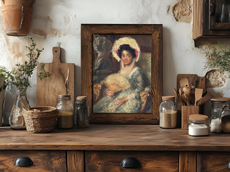 Framed vintage painting of a woman with a fan, on a rustic kitchen shelf. Surrounded by jars, wooden boards, and herbs, adding a cozy, nostalgic feel.