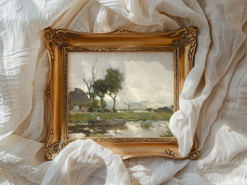 A framed landscape painting with trees and a small cottage is set against flowing white fabric. The scene conveys a serene, nostalgic mood.