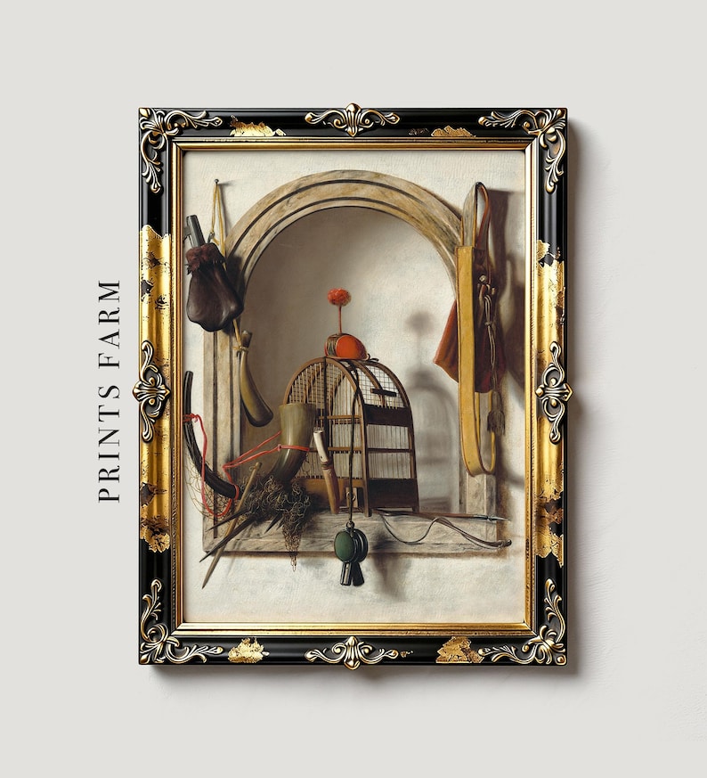 Framed painting features an arched niche with rustic still life objects: a birdcage, saddle, hunting gear, and a stick with an orange pom-pom. The setting evokes a vintage feel.
