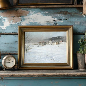 Framed winter landscape painting on rustic shelf with vintage clock, lamp, and potted plants. The weathered blue paint creates a nostalgic atmosphere.