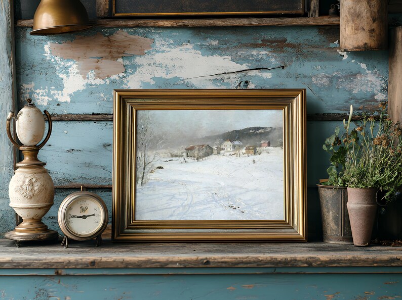 Framed winter landscape painting on rustic shelf with vintage clock, lamp, and potted plants. The weathered blue paint creates a nostalgic atmosphere.