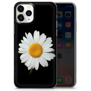 May include: A clear phone case with a white daisy on a black background. The daisy has a yellow center and white petals.