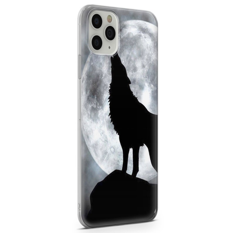 May include: A clear phone case with a black silhouette of a wolf howling at a full moon.