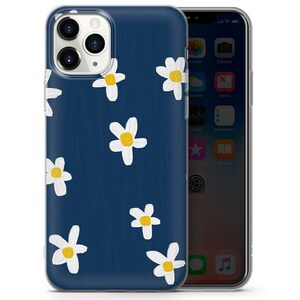 May include: A clear phone case with a navy blue background and a white daisy pattern. The daisies have yellow centers.