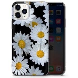 May include: A clear phone case with a black background and a pattern of white daisies. The daisies have yellow centers.