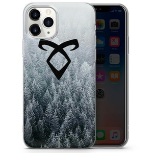 May include: A clear phone case with a black symbol and a snowy forest background. The symbol is a stylized rune with two curved lines forming a diamond shape.