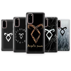May include: Set of five phone cases featuring the angelic power symbol from the Shadowhunters series. The cases are black with different designs, including a white symbol, a gold symbol, a marble design, and a forest design.