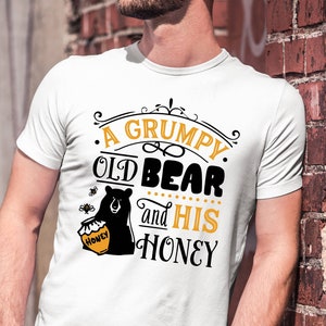 May include: White t-shirt with a black bear graphic and the text "A Grumpy Old Bear and His Honey".