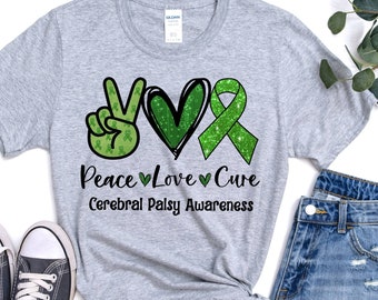 May include: A gray t-shirt with a green peace sign, heart, and ribbon with the text "Peace Love Cure Cerebral Palsy Awareness".