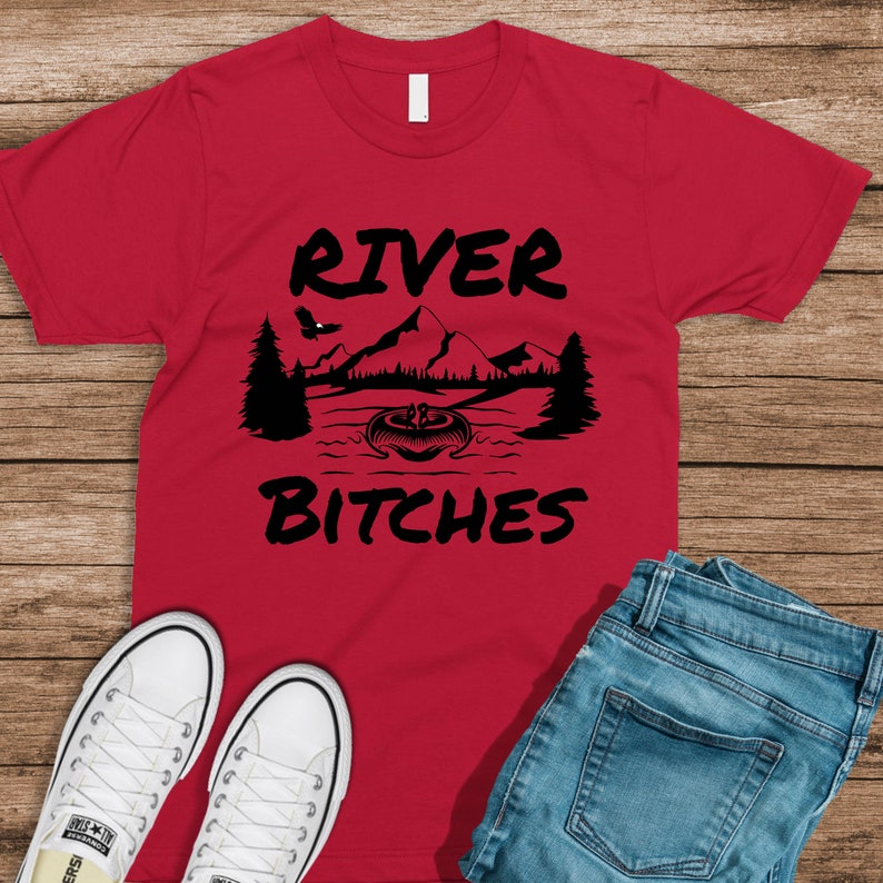 May include: Red t-shirt with a black graphic of a mountain scene and the text "River Bitches".