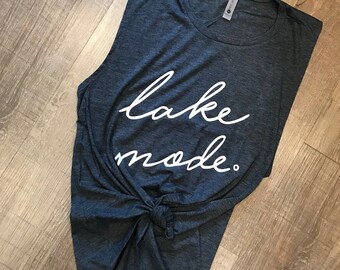 May include: A dark gray sleeveless shirt with the text "lake mode." printed in white.