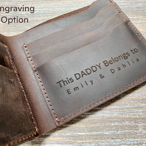 a leather wallet with a name tag on it