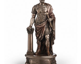 May include: A bronze-toned statue of a bearded man in Roman military armor, standing beside a column. He holds a staff in one hand and rests the other on the pillar. The base features the engraved text: THE HAPPINESS OF YOUR LIFE DEPENDS ON THE QUALITY OF YOUR THOUGHTS - MARCUS AURELIUS.