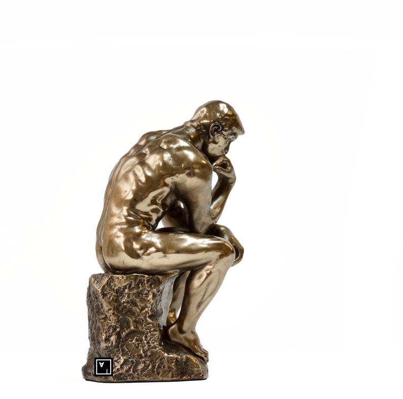 May include: A bronze sculpture of a seated man with his chin resting on his hand, in a contemplative pose. The sculpture is on a rough, textured base.