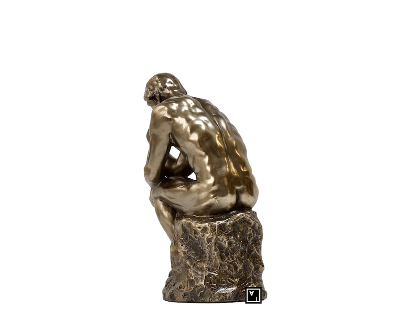 May include: A bronze sculpture of a man sitting in a contemplative pose, with his head resting on his hand. The sculpture is mounted on a rough, textured base.