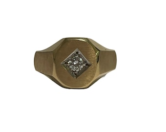 May include: A gold signet ring with a single diamond set in a square shape.