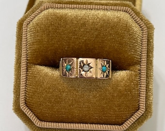 May include: A gold ring with three stones set in a starburst design. The stones are turquoise and white.