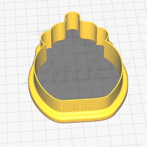 May include: Yellow plastic cookie cutter shaped like a baby bottle. The cutter has a rounded top with a raised rim and a flat bottom with the words "Baby Bottle" inscribed.