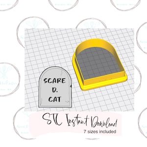 May include: A yellow plastic cookie cutter shaped like a tombstone with the text "SCARE D. CAT" on it. The cookie cutter is on a gray grid background.