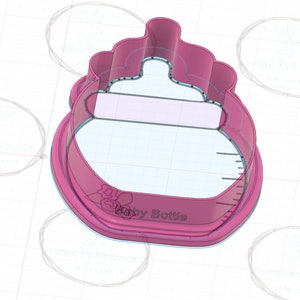 May include: Pink plastic baby bottle cookie cutter with a floral design and the text "Baby Bottle" on the bottom.