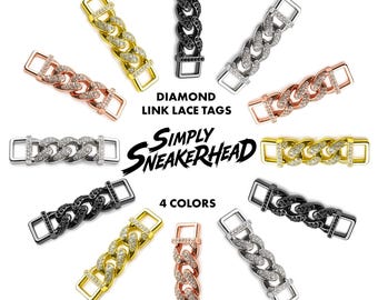 May include: A collection of rectangular metal lace tags featuring a cuban link chain design encrusted with small clear or black stones. The tags are arranged in a circular pattern around the text DIAMOND LINK LACE TAGS, SIMPLY SNEAKERHEAD, and 4 COLORS. The metal finishes include gold, silver, rose gold, and black tones.