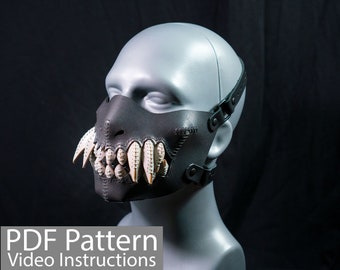 May include: A black leather mask with a stitched design and a set of white teeth. The mask has a strap that goes around the head.  PDF Pattern Video Instructions.