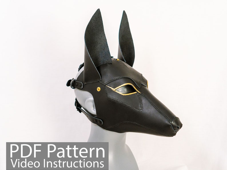 May include: Black leather mask with gold accents, resembling an animal head with pointed ears. The mask has a strap for the head and eye holes.  PDF Pattern Video Instructions.