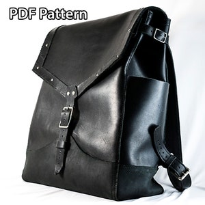 May include: A black leather backpack with a flap closure and a buckle. The backpack has a large main compartment and a smaller front pocket. The backpack is made of high-quality leather and has a durable construction.