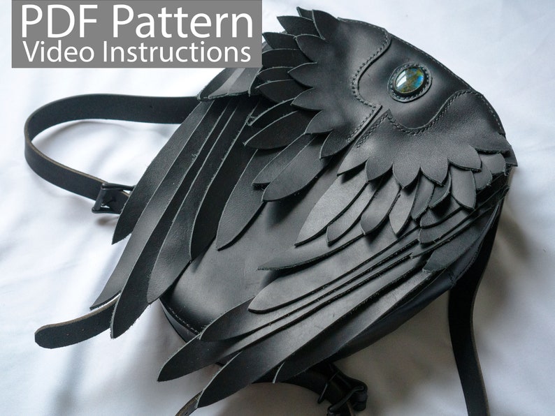 May include: Black leather backpack with large wings, featuring a decorative gemstone eye.  PDF Pattern Video Instructions.