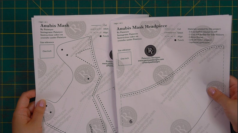 May include: A set of three white paper patterns for crafting an Anubis mask. The patterns include instructions for cutting, stitching, aligning, and punching. The patterns are labeled "Anubis Mask" and "Anubis Mask Headpiece".