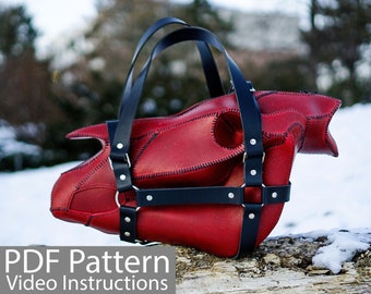 May include: Red leather bag with black straps and silver hardware. The bag is shaped like a head and has a stitched design. The text "PDF Pattern Video Instructions" is at the bottom of the image.