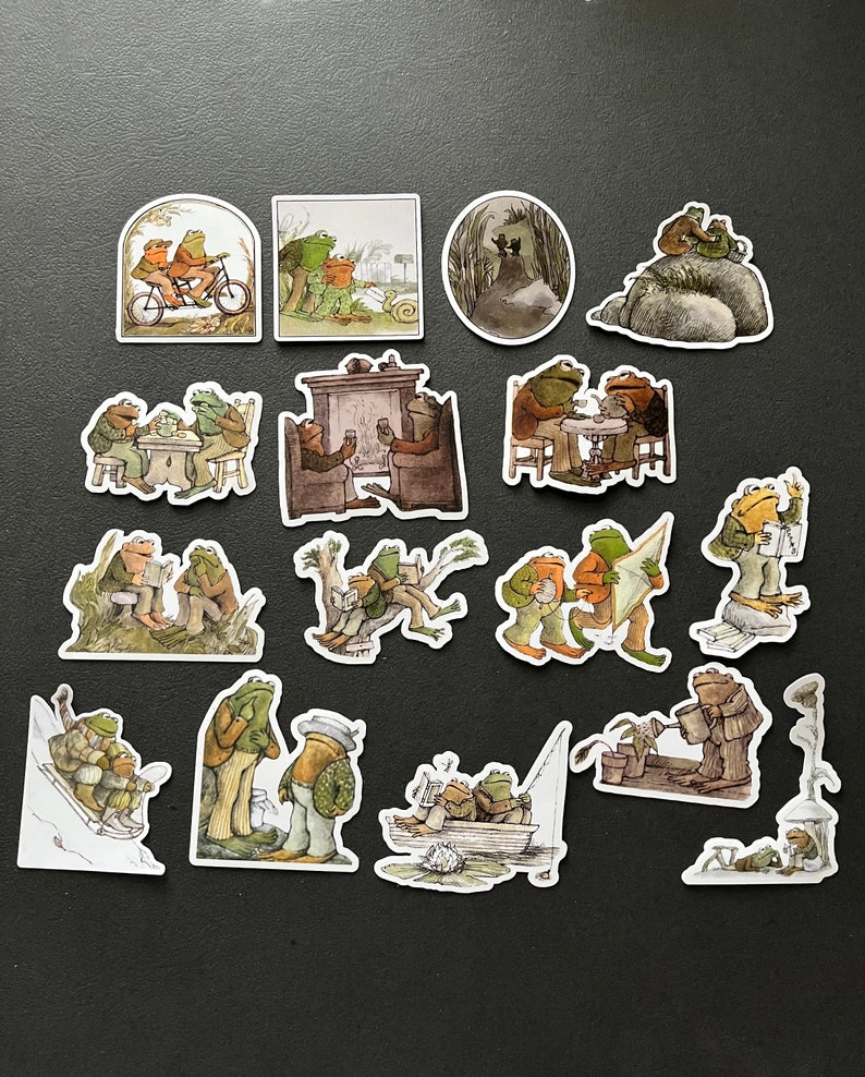 Puede incluir: Un conjunto de 17 pegatinas con tem&aacute;tica de ranas que representan varias escenas, incluyendo ranas montando en bicicleta, ranas tomando el t&eacute;, ranas junto a una chimenea y ranas en un bote. Las pegatinas est&aacute;n impresas en papel blanco con un acabado brillante.