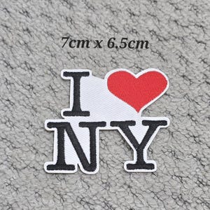 May include: Embroidered patch featuring the text "I NY" and a red heart. The patch is white with black lettering and a red heart. The patch measures 7cm x 6.5cm.