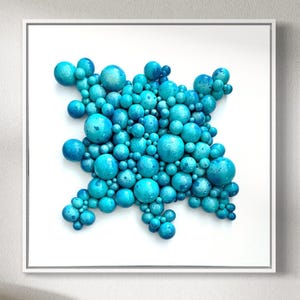 Turquoise abstract wooden balls on canvas board