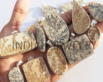 May include: A collection of 10 silver pendants featuring dendritic agate stones. The stones are a mix of brown, white, and black with a unique dendritic pattern. The pendants are all different shapes and sizes.