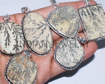 May include: Six silver pendants with dendritic agate stones. The stones are white with black dendritic patterns. The pendants are all different shapes and sizes.