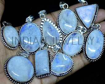 May include: A collection of 10 silver pendants with moonstone gemstones. The pendants are oval, teardrop, and triangular shaped. The moonstone gemstones are iridescent and have a blue sheen.