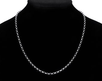 May include: A silver-colored chain necklace with a series of small, circular links. The necklace is displayed on a black mannequin, creating a contrast that highlights the jewelry's shine. The chain is a simple, elegant design.