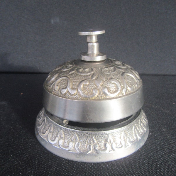 Vintage victorian style silvertone cast metal service bell,antique silver colour ornately decorated counter,hotel desk,bell.