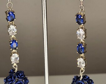 30) Ornate, interesting blue flowered bead dangling below sapphire and clear rhinestones