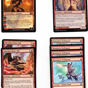 May include: A collection of Magic: The Gathering trading cards. Featured cards include "Chandra, the Firebrand," "Pinnacle Monk," "Slickshot Show-Off," and multiple "Monastery Swiftspear" cards. The cards have red and black color schemes.