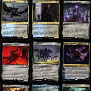 May include: Nine Magic: The Gathering trading cards featuring characters like the Witch-king, Sauron, and Ringwraiths. The cards have various art styles and colours, with text descriptions and mana symbols.