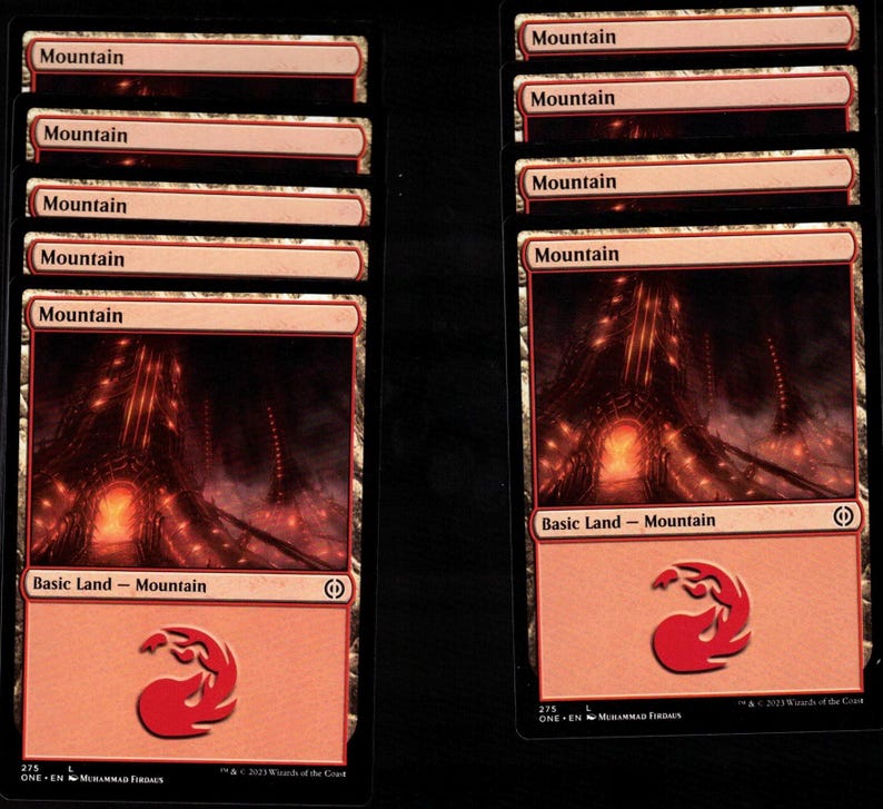 May include: Two stacks of "Mountain" Magic: The Gathering trading cards. Each card features a red and orange landscape with a mountain range and a red mana symbol. The text "Basic Land - Mountain" is visible.