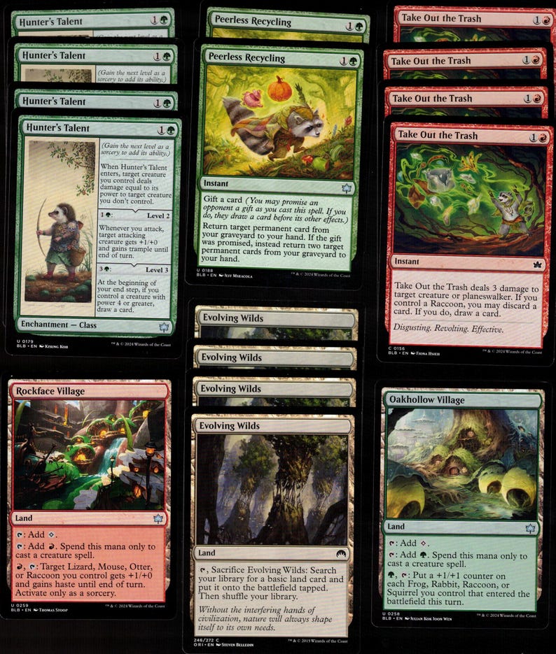 May include: A collection of Magic: The Gathering trading cards. The cards feature various illustrations, including a raccoon, a forest scene, and text. The cards are in English and are designed for gameplay.