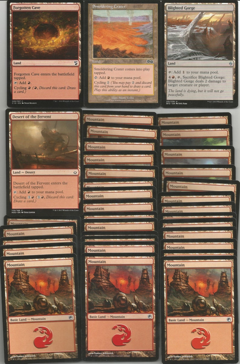 May include: A collection of Magic: The Gathering cards featuring various lands, including Forgotten Cave, Smoldering Crater, Blighted Gorge, and Desert of the Fervent. The cards are in various shades of brown, red, and green, with illustrations depicting volcanic landscapes, caves, and mountains.