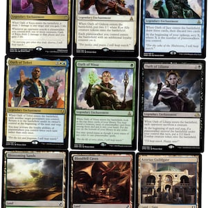 May include: A set of ten Magic: The Gathering cards featuring various legendary enchantments, lands, and a gate card. The cards are in a black border frame with colorful illustrations and text.