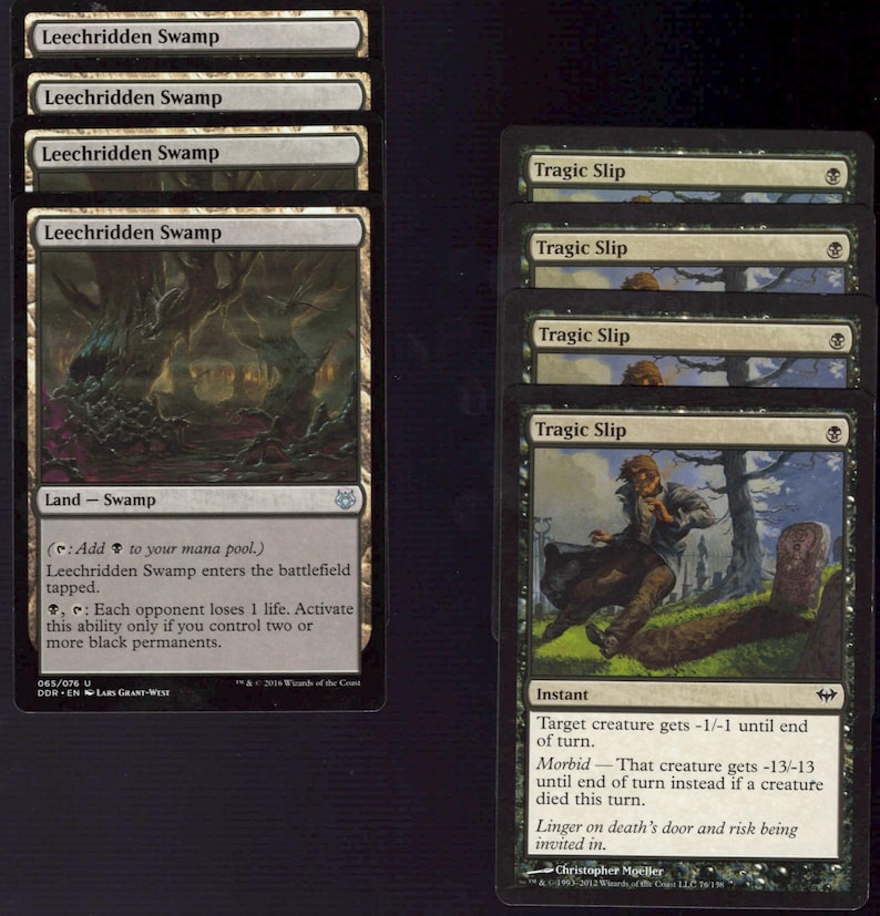 May include: A collection of Magic: The Gathering trading cards. The cards feature swamp and instant spells with dark artwork and text descriptions. The cards are black and white with green accents.